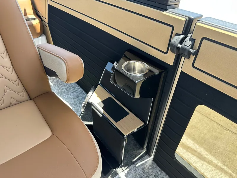 Slide: The Image of Interior of a 2027 Revel RL23 with beige seating and an integrated cup holder. - 23