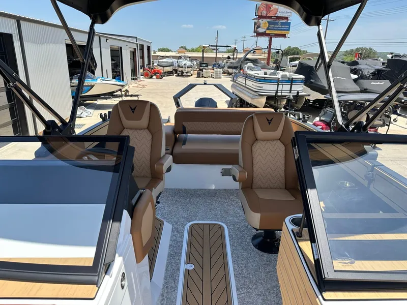 Slide: The Image of The image shows the cockpit of a Revel RL23 boat with brown seats and a modern design. - 17