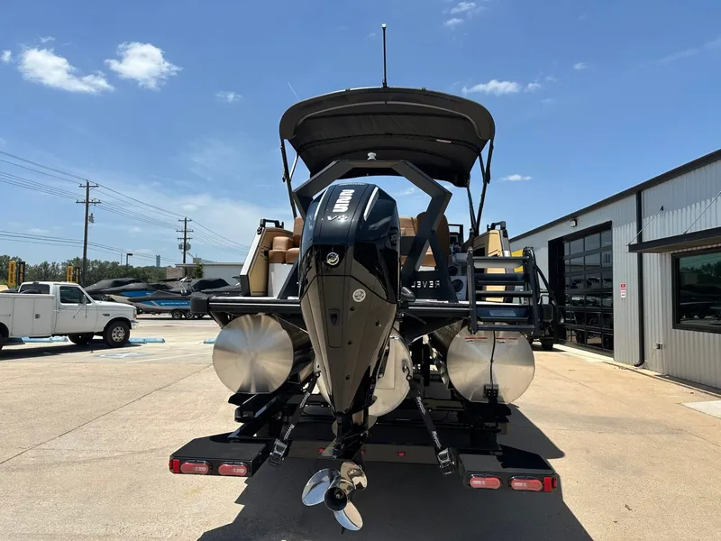 Slide: The Image of A modern boat with a powerful outboard motor sits on a trailer in a sunny marina. - 4