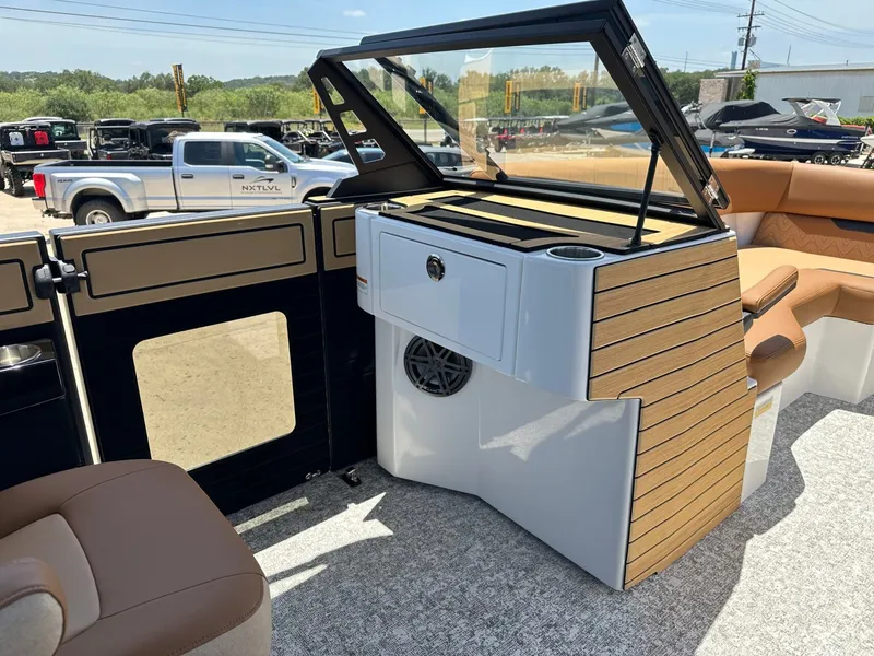 Slide: The Image of The image shows the cockpit of a 2027 Revel RL23 boat with sleek wood accents. - 24