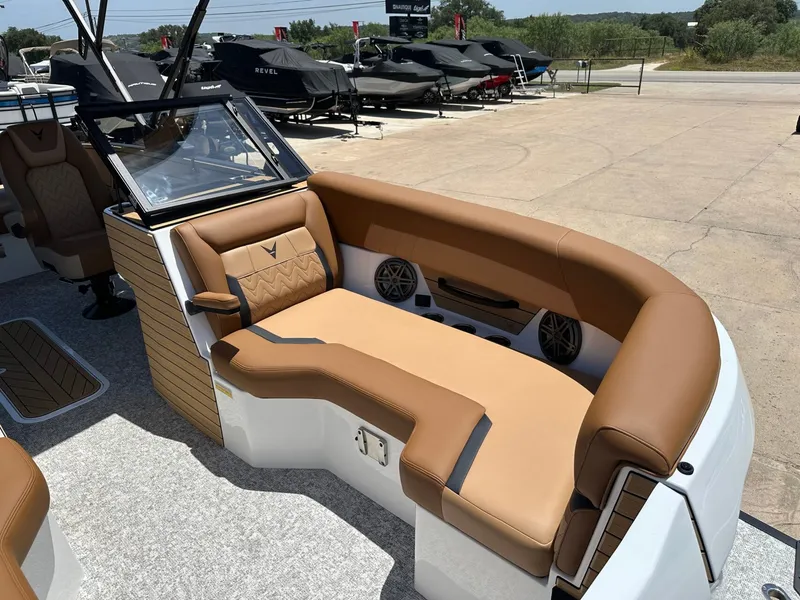 Slide: The Image of The image shows the cockpit of a 2027 Revel RL23 with brown leather seating. - 15