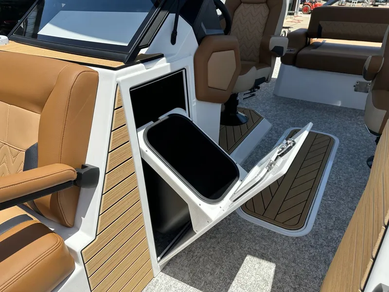 Slide: The Image of The image shows the interior of a 2027 Revel RL23 boat with brown seating and storage space. - 19