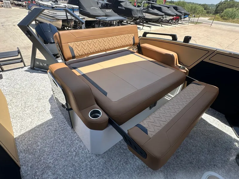 Slide: The Image of The image shows the luxurious cockpit of a 2027 Revel RL23 with brown upholstery and cup holders. - 37