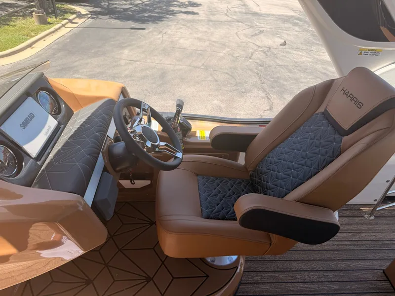 Slide: The Image of The image shows the helm of a Harris Grand Mariner 250 with a luxurious captain's chair. - 17