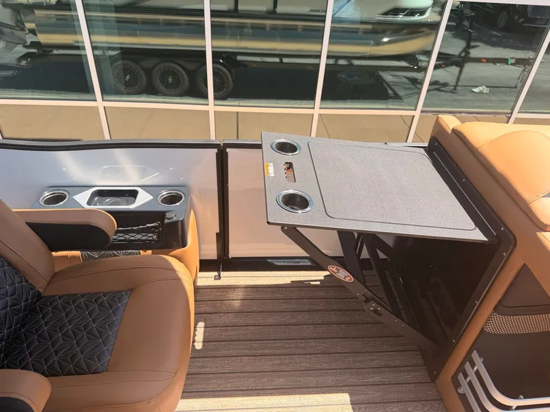 Slide: The Image of Interior of a 2027 Harris Grand Mariner 250 with luxurious seating and a foldable table. - 20