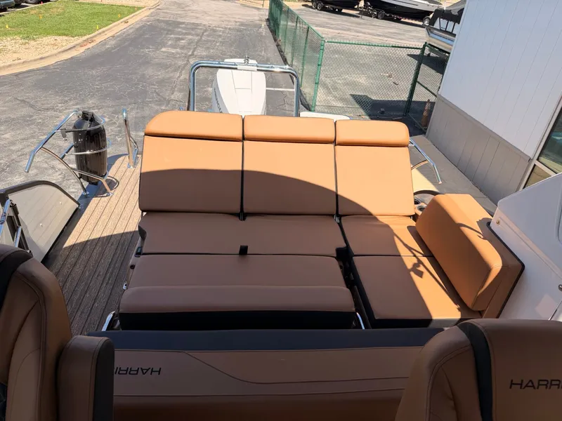 Slide: The Image of The image shows the sun deck of a 2027 Harris Grand Mariner 250 with beige upholstery. - 10