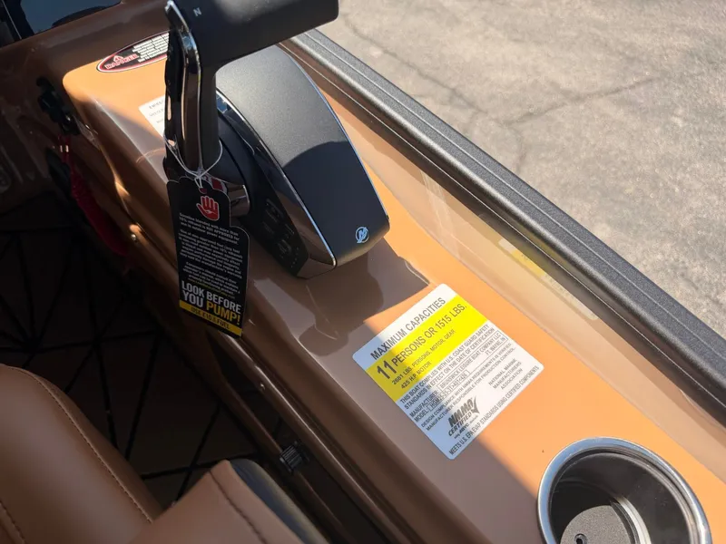 Slide: The Image of Close-up of a Harris Grand Mariner 250's control area with warning labels and a cup holder. - 24