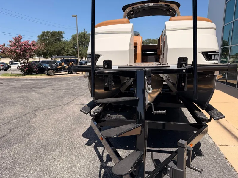 Slide: The Image of A 2027 Harris Grand Mariner 250 on a trailer, ready for transport. - 7