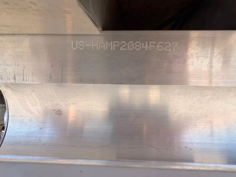 Slide: The Image of Close-up of a metal surface with an engraved serial number. - 27