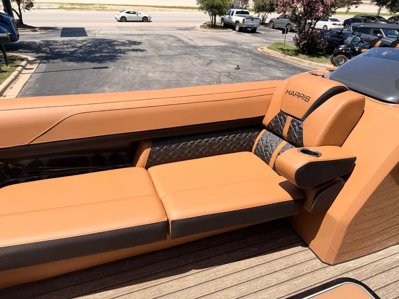 Slide: The Image of The image shows the luxurious orange seating of a 2027 Harris Grand Mariner 250. - 14