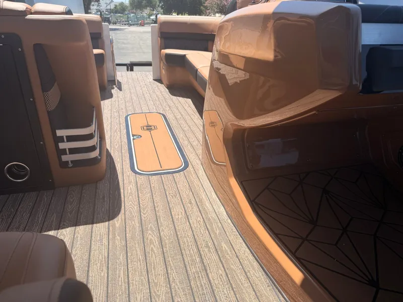 Slide: The Image of The image shows the interior of a 2027 Harris Grand Mariner 250 with sleek seating and wood flooring. - 21
