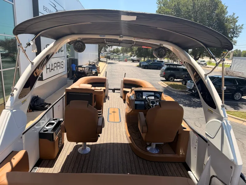 Slide: The Image of The image shows the interior of a 2027 Harris Grand Mariner 250. It features brown seating and a modern dashboard. - 8