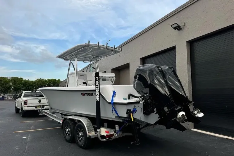 Slide: The Image of 2026 Contender 28 Tournament boat on trailer, parked near a building. - 5