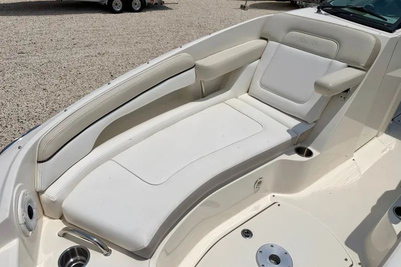 Slide: The Image of 2013 Sea Ray 260 Sundeck boat interior with white cushioned seating. - 11