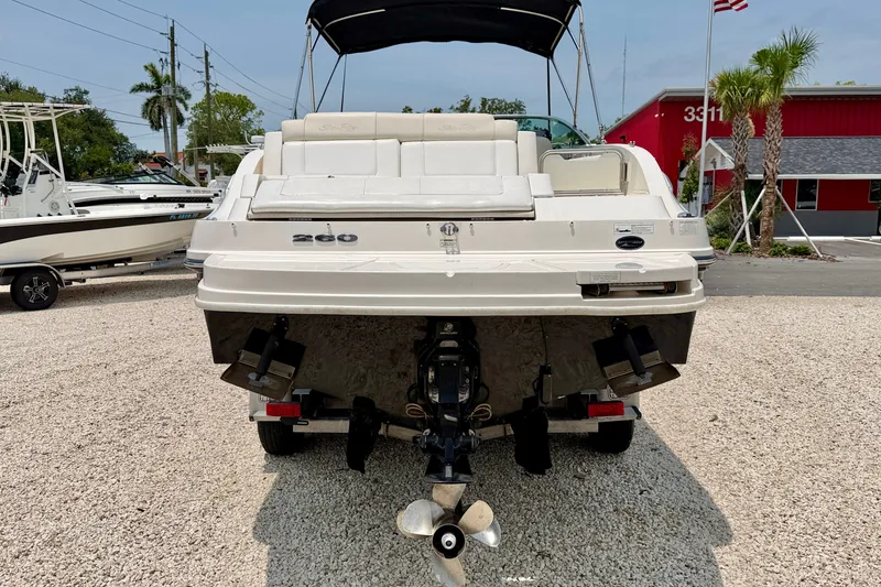 Slide: The Image of Rear view of a 2013 Sea Ray 260 Sundeck boat on a gravel lot. - 5