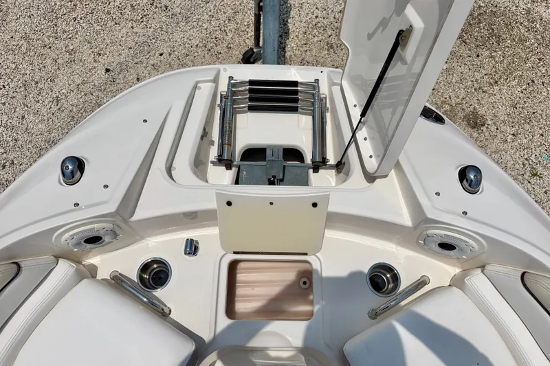 Slide: The Image of 2013 Sea Ray 260 Sundeck boat interior with open storage compartment and seating area. - 28