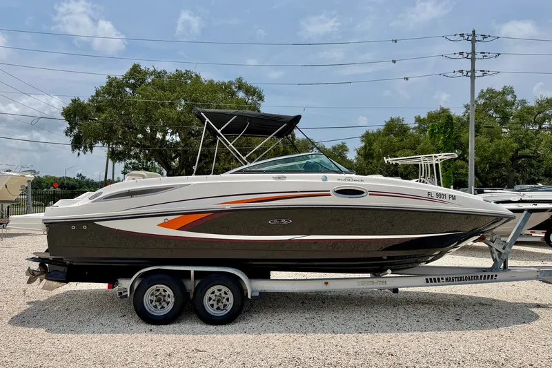 Slide: The Image of 2013 Sea Ray 260 Sundeck boat on trailer, parked outdoors. - 7