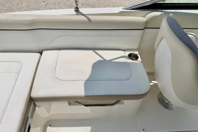 Slide: The Image of 2013 Sea Ray 260 Sundeck interior with white seating and cup holder. - 25