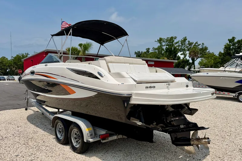 Slide: The Image of 2013 Sea Ray 260 Sundeck boat on trailer, parked outdoors. - 4