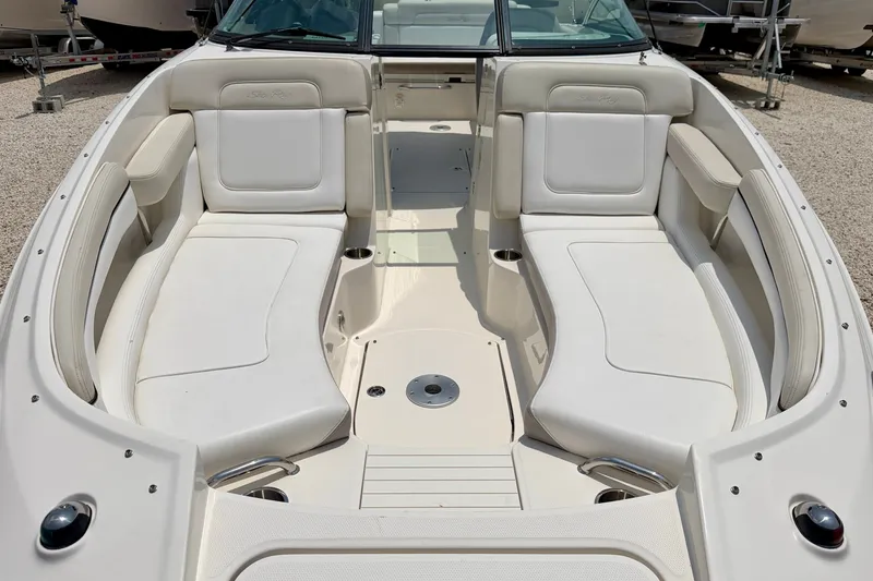 Slide: The Image of 2013 Sea Ray 260 Sundeck boat interior with white seating and spacious layout. - 9