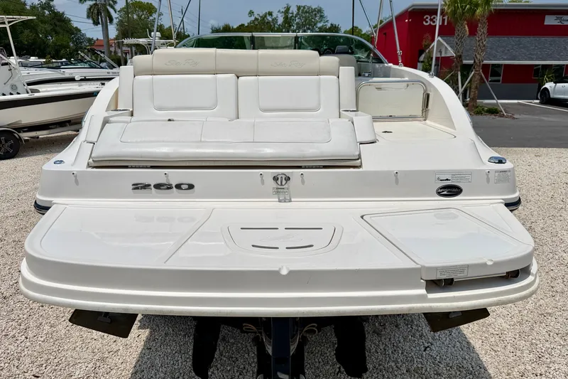 Slide: The Image of 2013 Sea Ray 260 Sundeck boat, rear view, showcasing spacious seating and swim platform. - 26