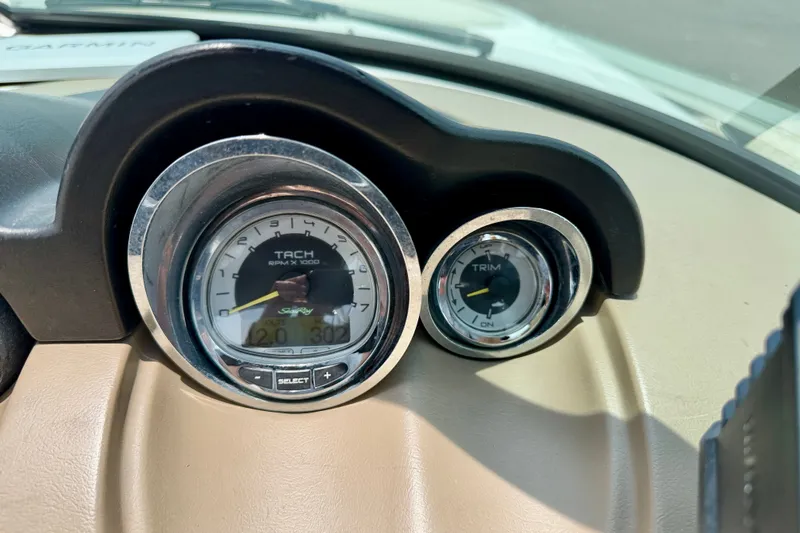 Slide: The Image of Dashboard gauges of a 2013 Sea Ray 260 Sundeck boat, showing tachometer and trim indicators. - 16