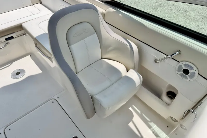 Slide: The Image of 2013 Sea Ray 260 Sundeck interior with white seating and stainless steel accents. - 22