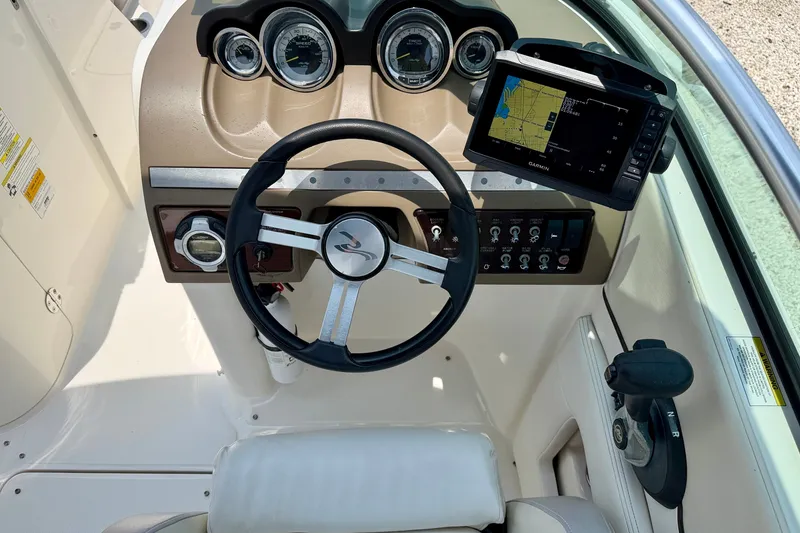 Slide: The Image of Steering console of a 2013 Sea Ray 260 Sundeck with navigation display. - 14
