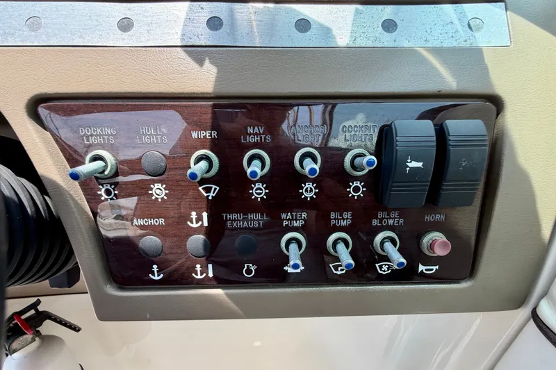 Slide: The Image of Control panel of a 2013 Sea Ray 260 Sundeck boat with various switches. - 19