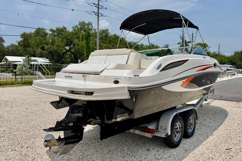 Slide: The Image of 2013 Sea Ray 260 Sundeck boat on trailer, featuring sleek design and bimini top. - 6