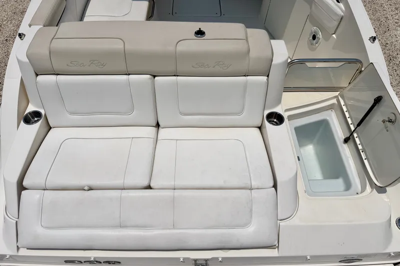 Slide: The Image of 2013 Sea Ray 260 Sundeck boat interior with white seating and storage compartment. - 24