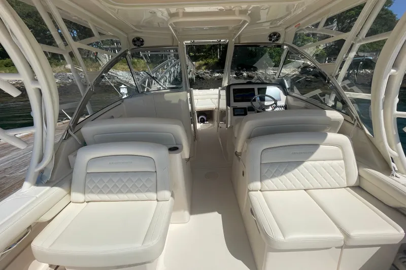 Slide: The Image of 2021 Grady-White Freedom 325 boat interior with luxurious seating and modern dashboard. - 10