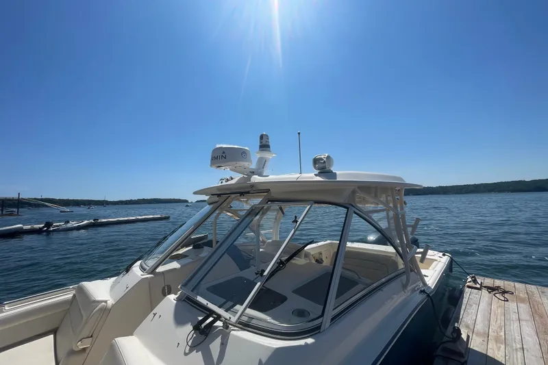 Slide: The Image of 2021 Grady-White Freedom 325 boat docked on a sunny day by the water. - 5