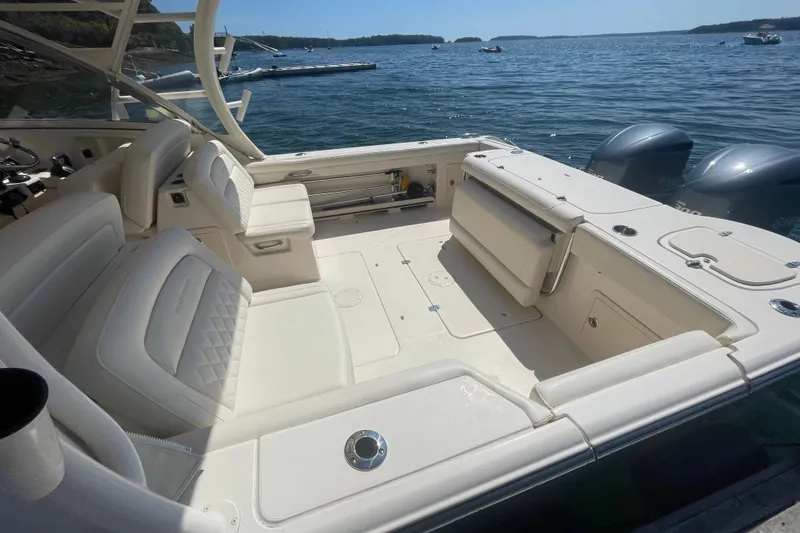 Slide: The Image of 2021 Grady-White Freedom 325 boat interior with seating, on a sunny day by the water. - 8