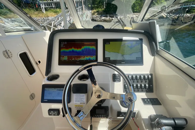 Slide: The Image of 2021 Grady-White Freedom 325 helm with advanced navigation displays and controls. - 15