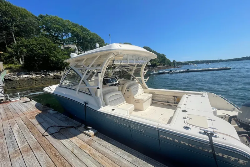 Slide: The Image of 2021 Grady-White Freedom 325 boat docked by a scenic waterfront. - 6