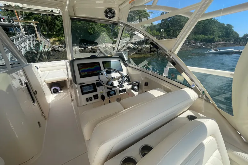 Slide: The Image of Interior of 2021 Grady-White Freedom 325 boat with modern dashboard and steering wheel. - 11