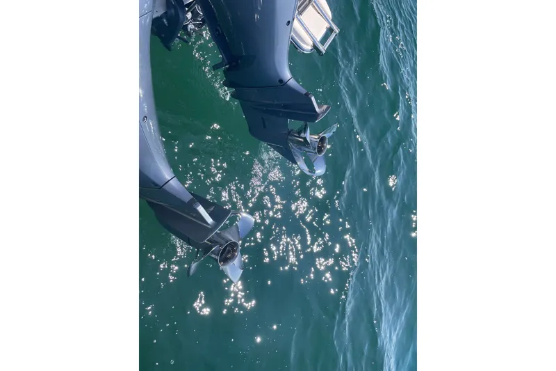 Slide: The Image of Outboard motors of a 2021 Grady-White Freedom 325 boat on sparkling water. - 25