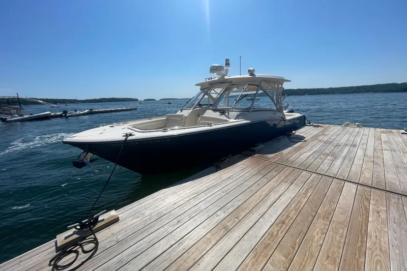 Slide: The Image of 2021 Grady-White Freedom 325 boat docked on a sunny day by the water. - 3