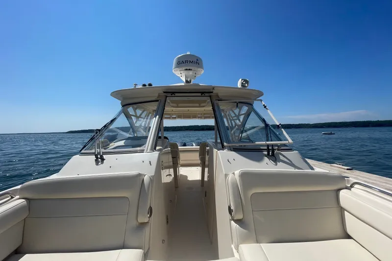 Slide: The Image of 2021 Grady-White Freedom 325 boat on calm water under clear blue sky. - 20