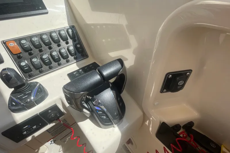 Slide: The Image of Control panel of a 2021 Grady-White Freedom 325 boat, featuring throttle and switches. - 29