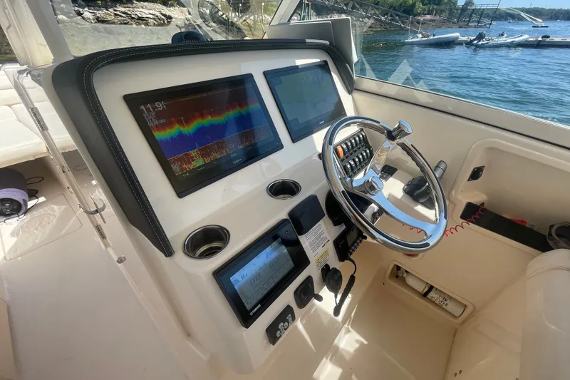 Slide: The Image of Helm of 2021 Grady-White Freedom 325 boat with advanced navigation displays. - 27