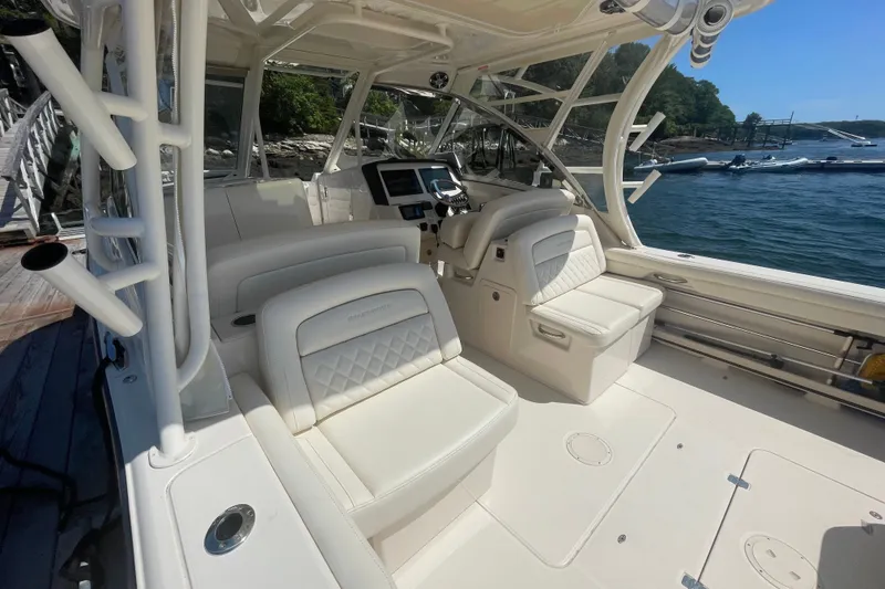 Slide: The Image of 2021 Grady-White Freedom 325 boat interior with luxurious seating and helm. - 9