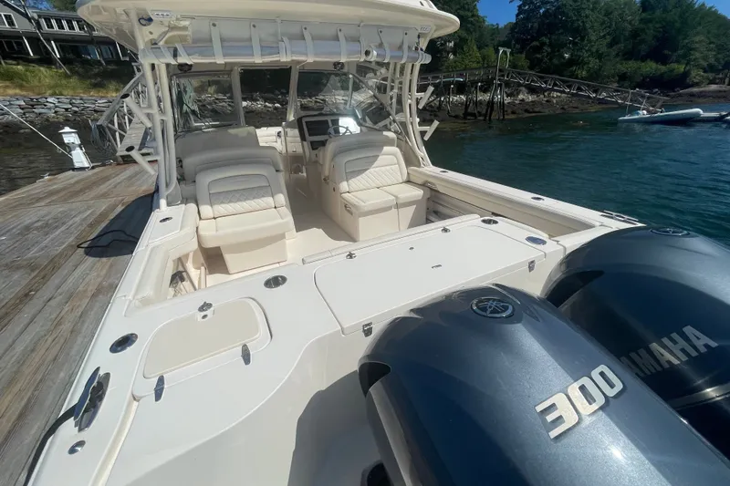 Slide: The Image of 2021 Grady-White Freedom 325 boat with Yamaha 300 engines docked by the water. - 26