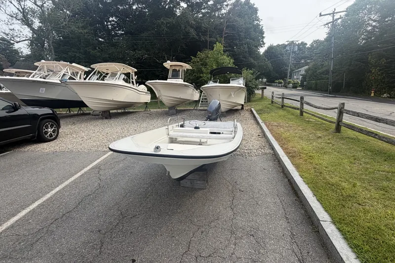 Slide: The Image of 1980 Boston Whaler Super Sport 15 boat displayed in a parking lot with other boats. - 5