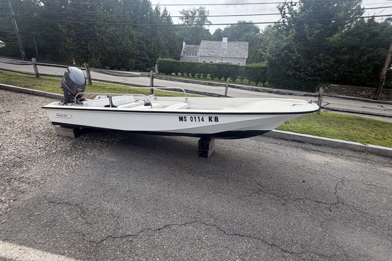 Slide: The Image of 1980 Boston Whaler Super Sport 15 boat parked on roadside. - 3