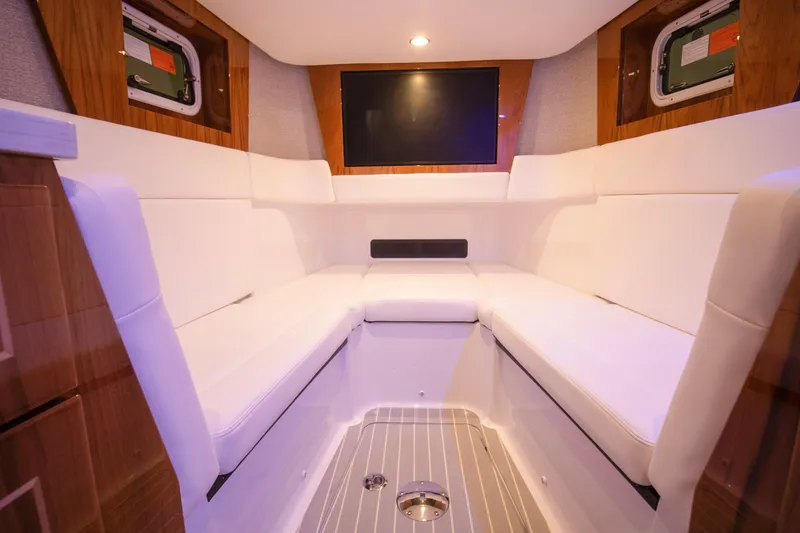 Slide: The Image of Luxurious interior of 2026 HCB 48 Campeon boat with white seating and wood accents. - 20