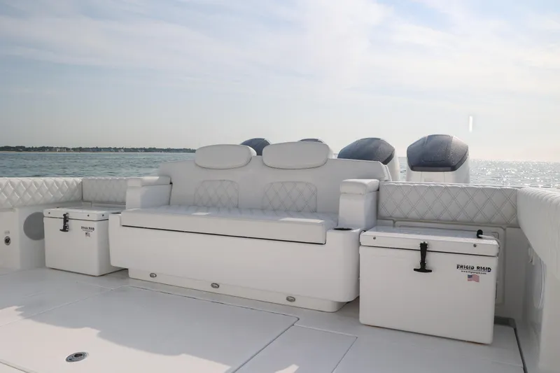 Slide: The Image of Luxurious seating on 2027 HCB 48 Campeon boat with ocean backdrop. - 7