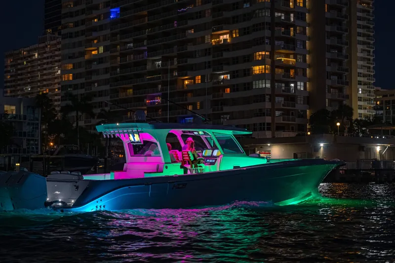 Slide: The Image of 2027 HCB 48 Campeon boat illuminated at night near city buildings. - 28