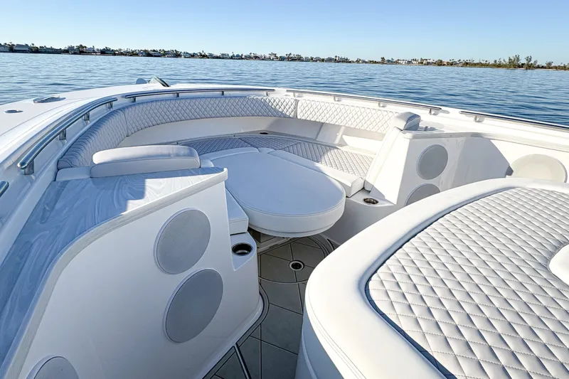 Slide: The Image of Luxurious seating area on the 2027 HCB 48 Campeon boat, with quilted upholstery and ocean view. - 30